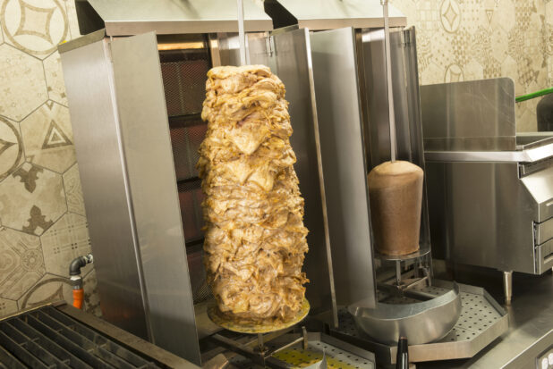Vertical broilers with shawarma and gyros with a slight side view