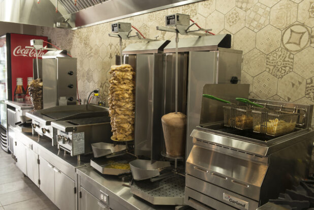 Middle eastern kitchen with vertical broilers, fryer, grill and flat top