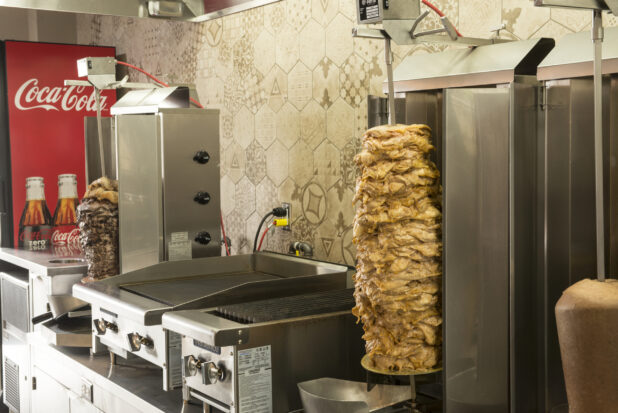 Middle eastern kitchen with vertical shawarma broiler, off centre side view