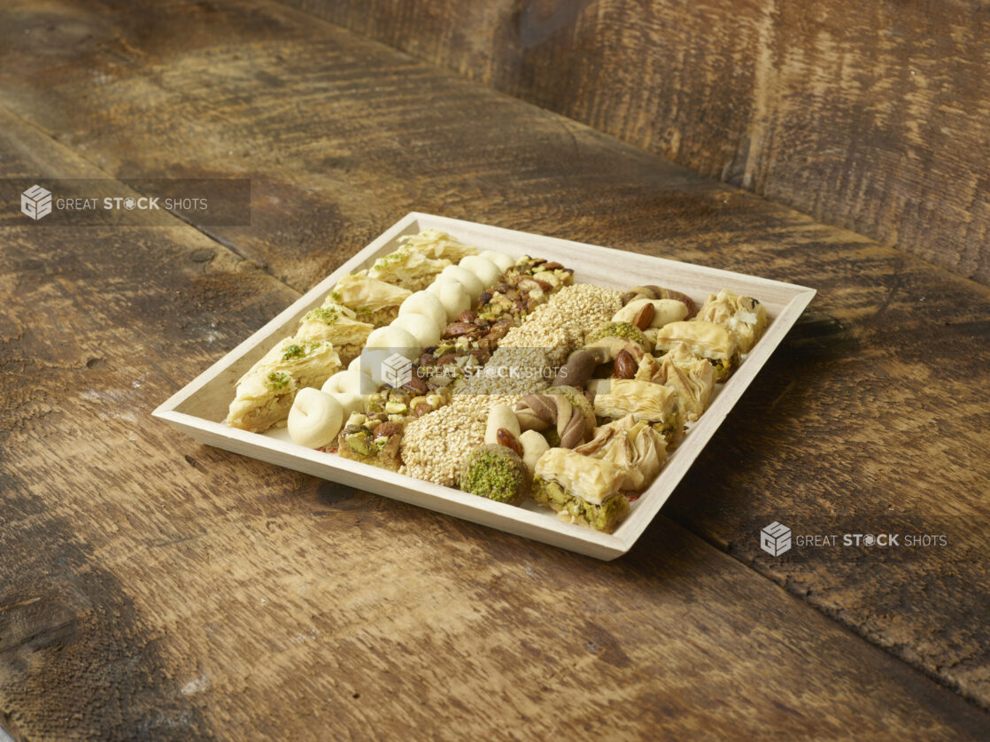 Pastries/Middle Eastern pastries on a wood tray displayed on an angle