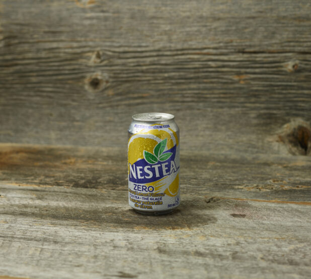 Nestea Zero, soda can, on a wooden table with wooden background