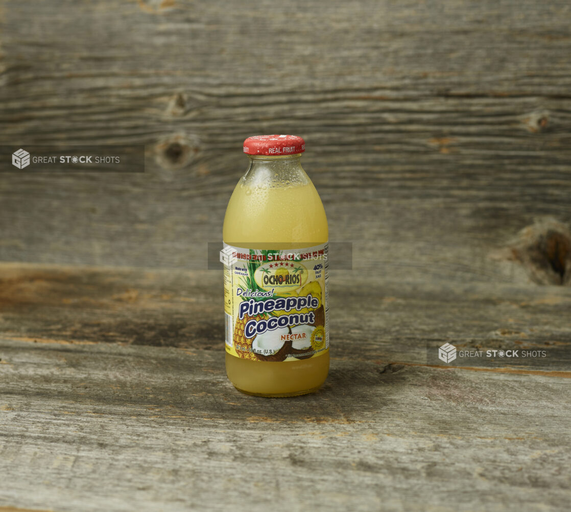 Juice in a glass bottle on wooden table with wooden background