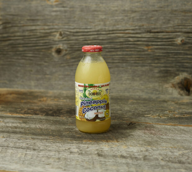 Juice in a glass bottle on wooden table with wooden background