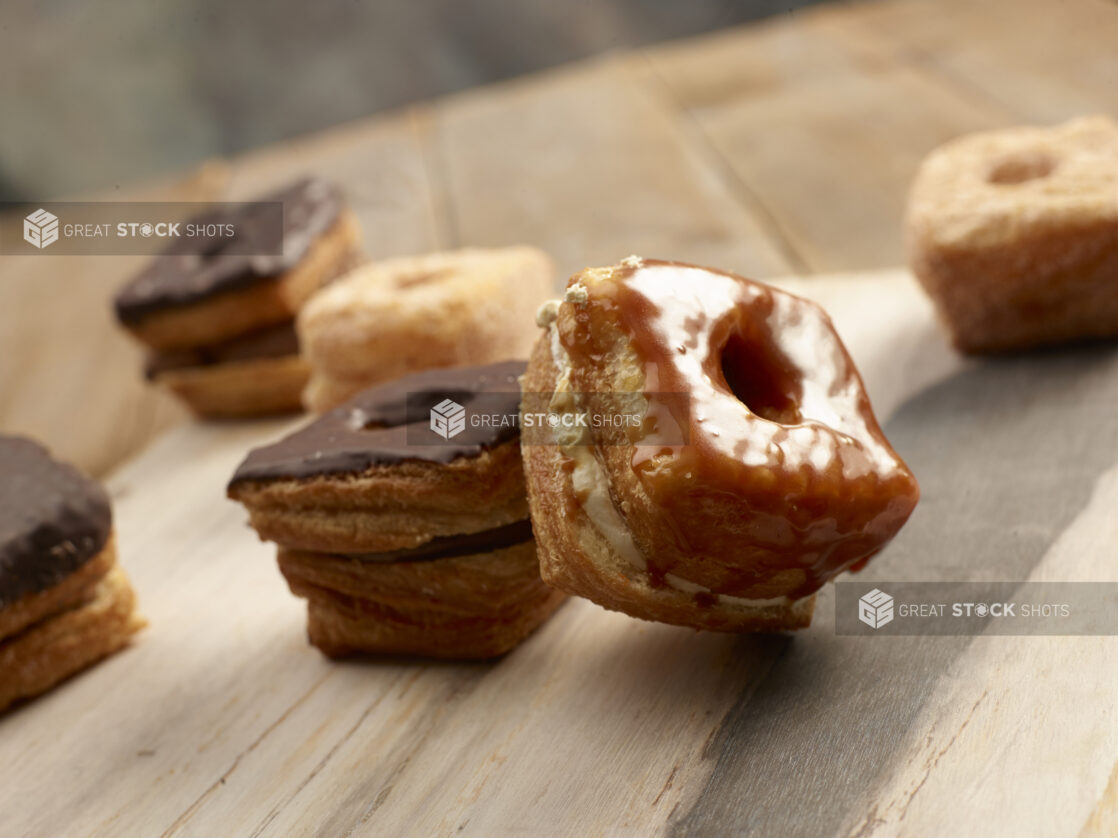 Fancy square donuts on a wooden background