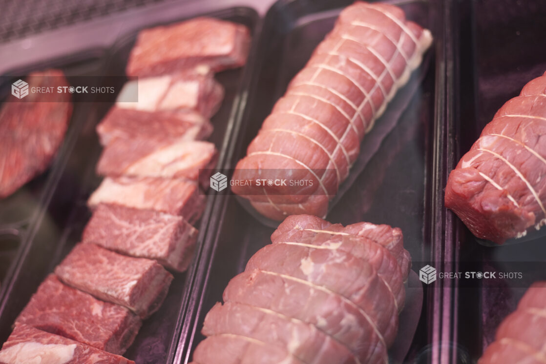 Close Up of Raw Beef Rib, Beef Tenderloin and Beef Brisket Prepared for Cooking, in the Butcher Section of a Gourmet Grocery Store