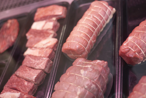 Close Up of Raw Beef Rib, Beef Tenderloin and Beef Brisket Prepared for Cooking, in the Butcher Section of a Gourmet Grocery Store