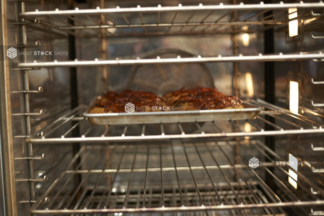 Tray of buns cooling on a steel rack, close-up