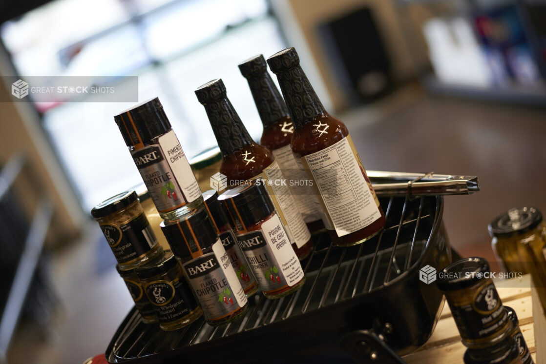 Sauces, Condiments and Seasonings for Grilling Season Displayed on a Grilling Pan in a Gourmet Grocery Store