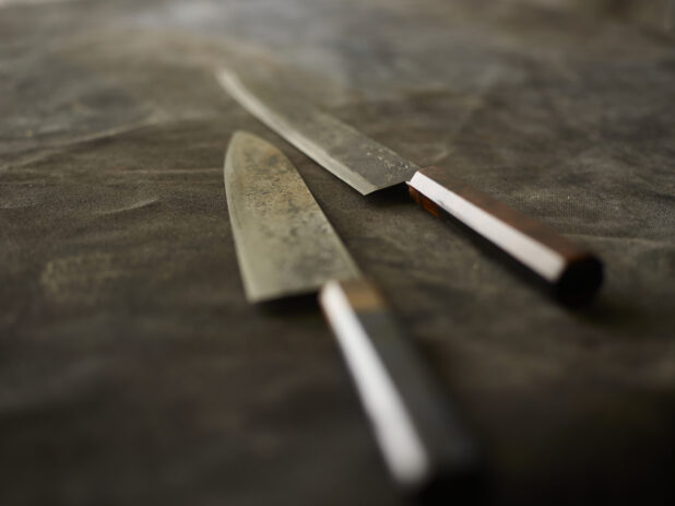 Kitchen knives on a dark cloth background