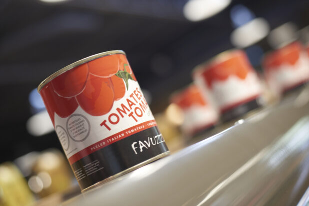 Can of tomatoes on a shelf, close-up