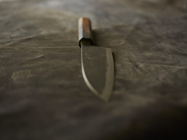 Kitchen knife on a dark cloth background