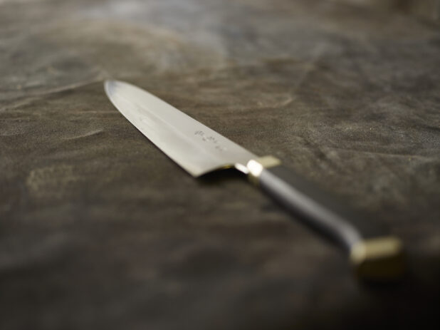 Kitchen knife on a black cloth background