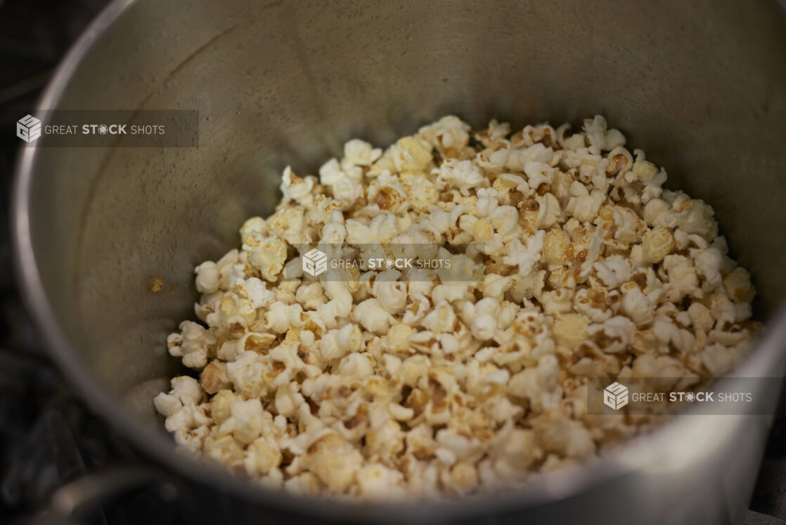 Close Up of an Industrial-Sized Soup Pot with Freshly Popped Plain Popcorn in a Gourmet Grocery Store Kitchen Setting