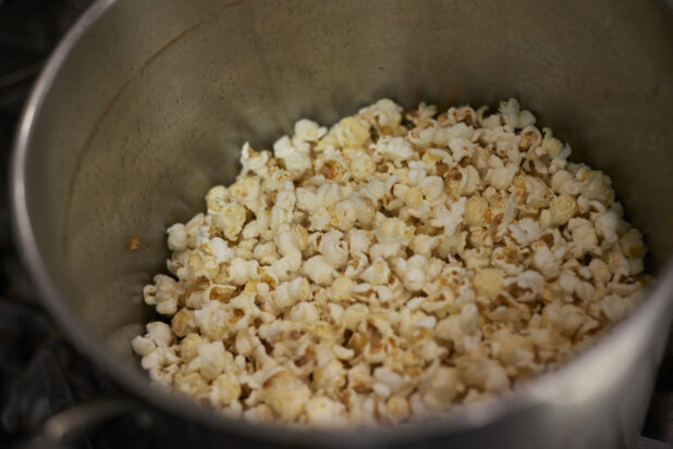 Close Up of an Industrial-Sized Soup Pot with Freshly Popped Plain Popcorn in a Gourmet Grocery Store Kitchen Setting