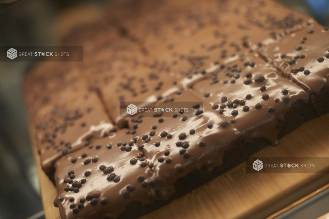 Iced chocolate brownies topped with chocolate decorations, close-up