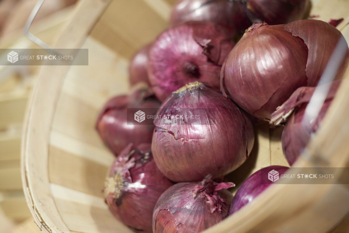 Bushel basket of red onions, close-up