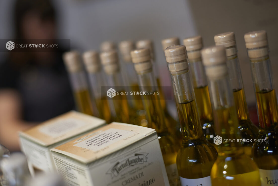 Close Up of Boxes of Tartuflanghe Italian Truffles and Bottles of High Quality Extra Virgin Olive Oil on a Shelf in a Gourmet Grocery Store Setting