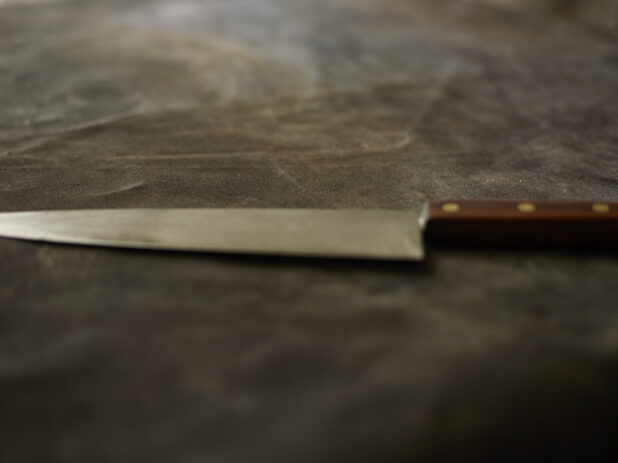 Kitchen knife on a black cloth background