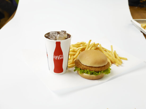 Fried Chicken Sandwich Combo with French Fries and a Fountain Soda in a Paper Cup with Ice Cubes, on a White Background for Isolation