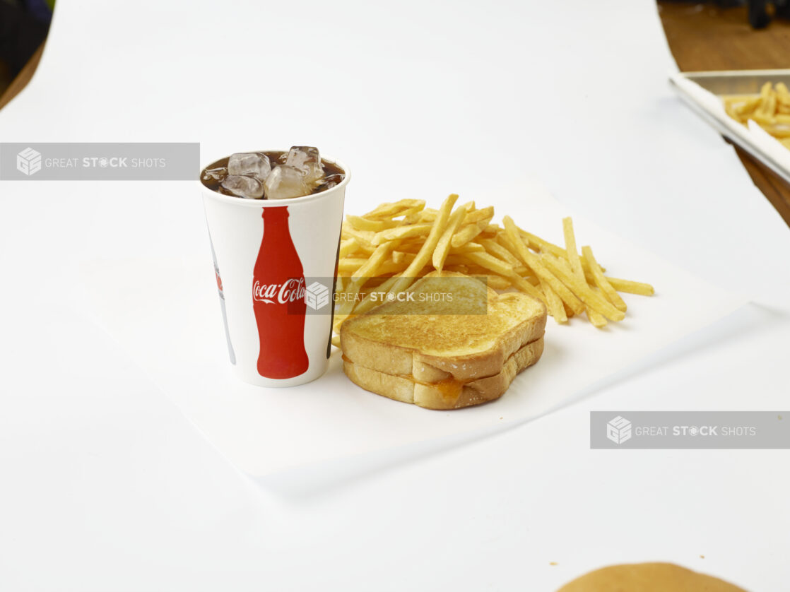 Grilled Cheese Sandwich Combo with French Fries and a Fountain Soda in a Paper Cup with Ice Cubes, on a White Background for Isolation