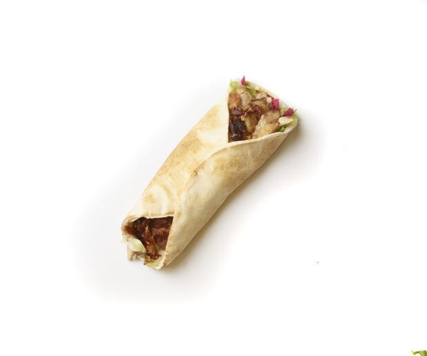 Overhead View of a Chicken Shawarma Pita Wrap with Fresh Vegetable Toppings, Shot on White for Isolation - Variation