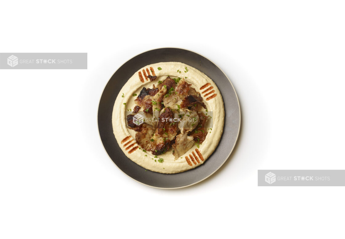 Overhead View of a Plate of Hummus Dip with Extra Virgin Olive Oil, Chicken Shawarma and Paprika Powder, Shot on a White Background for Isolation