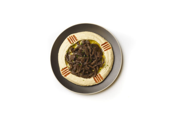 Overhead View of a Plate of Hummus Dip with Extra Virgin Olive Oil, Beef Shawarma and Paprika Powder, Shot on a White Background for Isolation