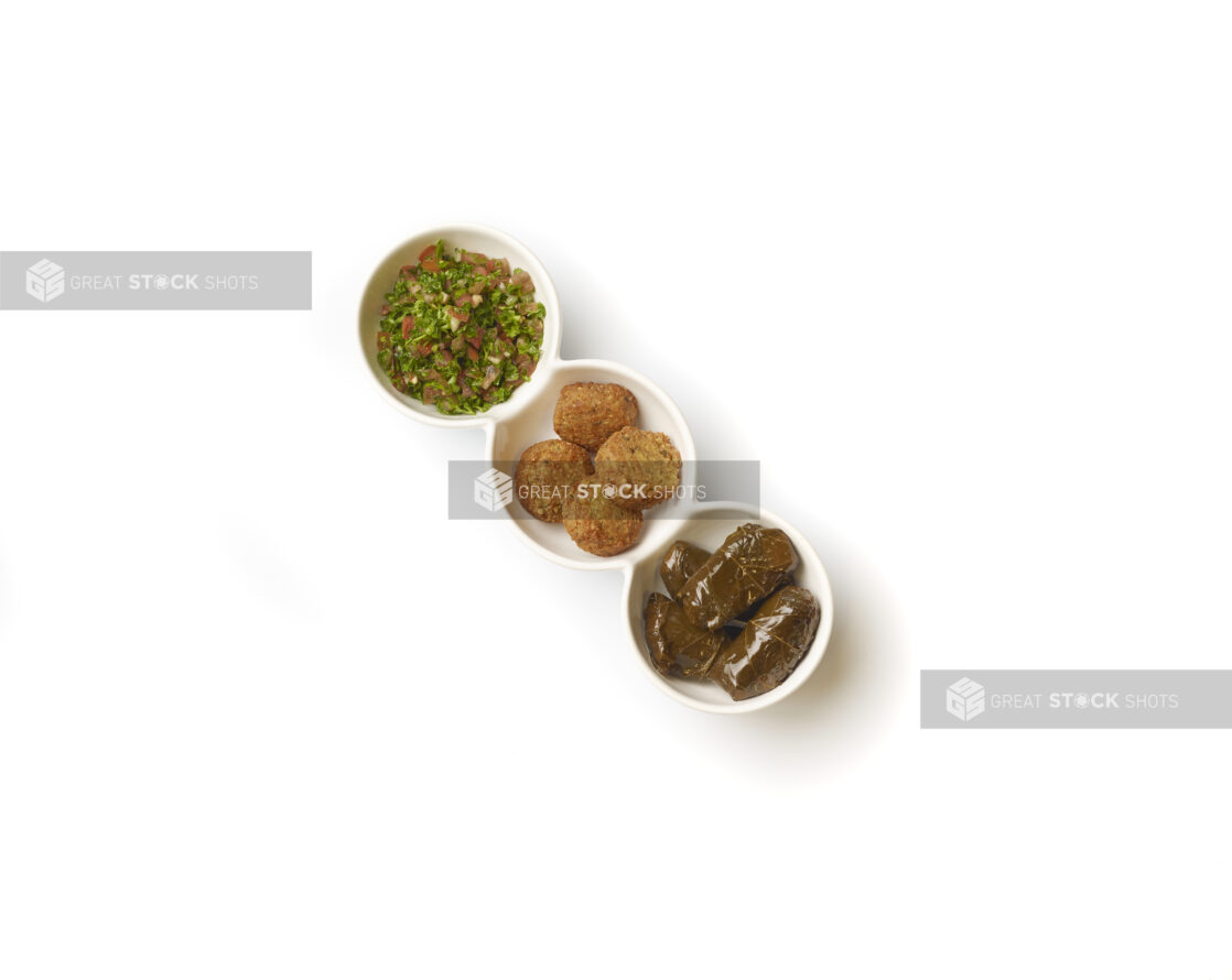 Overhead View of a Trio Plate of Side Dishes: Falafel Balls, Tabbouleh and Stuffed Grape Leaves, on a White Background for Isolation