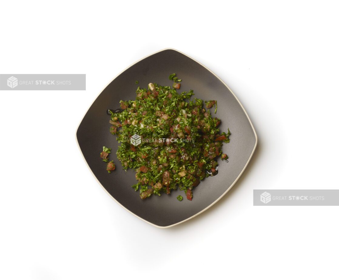 Overhead View of a Square Black Ceramic Dish of Tabbouleh - a Levantine Salad - on a White Background for Isolation