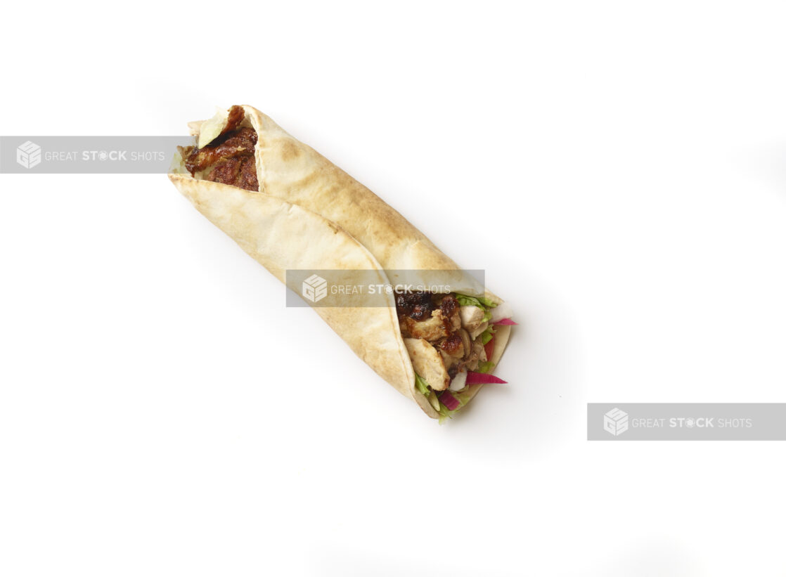 Overhead View of a Chicken Shawarma Pita Wrap with Fresh Vegetable Toppings, Shot on White for Isolation