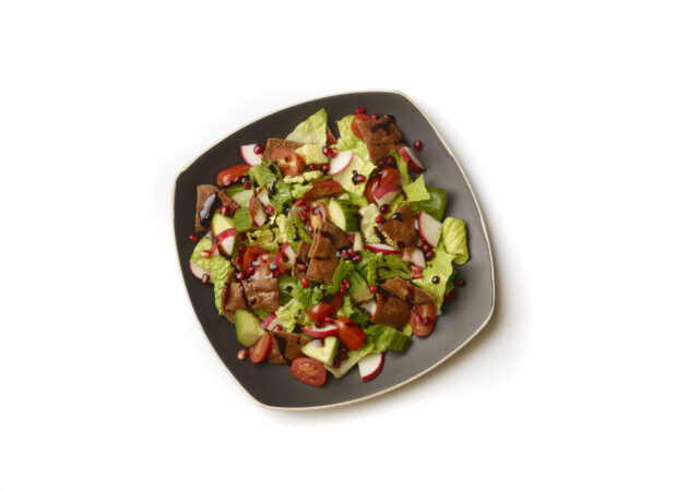 Overhead View of a Garden Salad with Gyro Meat and Balsamic Vinaigrette Drizzle on a Square Black Ceramic Dish, on a White Background for Isolation