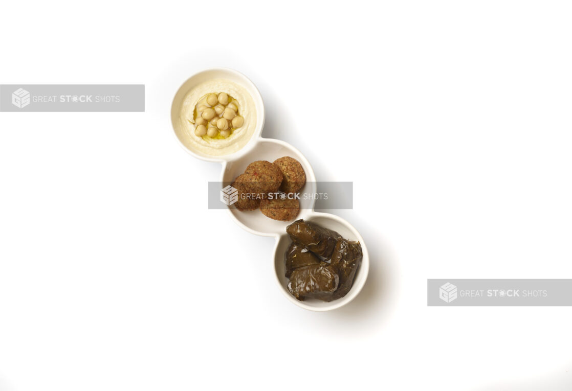 Overhead View of a Trio Plate of Side Dishes: Falafel Balls, Stuffed Grape Leaves and Hummus, on a White Background for Isolation