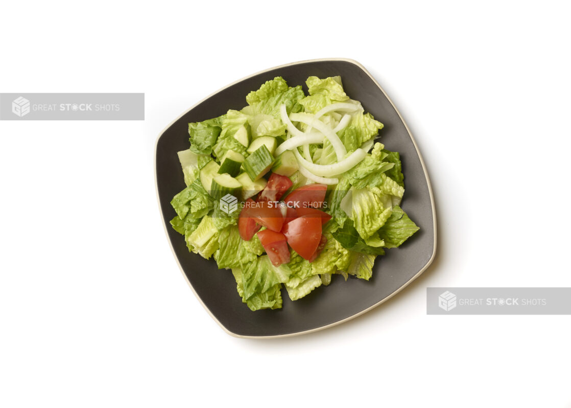 Overhead View of a Plain Garden Salad with Chopped Tomatoes, Cucumber and White Onions on a Square Black Ceramic Dish, on a White Background for Isolation