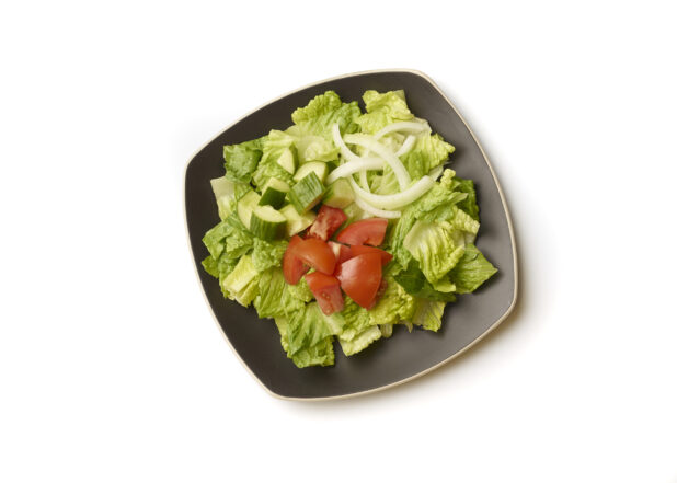 Overhead View of a Plain Garden Salad with Chopped Tomatoes, Cucumber and White Onions on a Square Black Ceramic Dish, on a White Background for Isolation