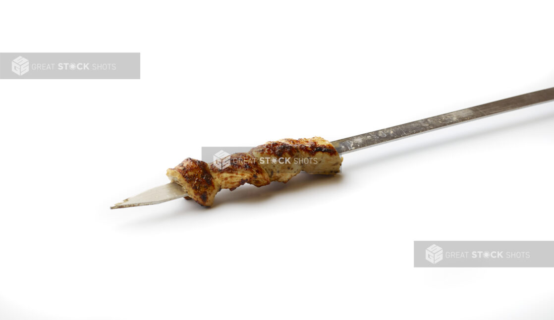 Chicken Souvlaki on a Metal Skewer, on a White Background for Isolation