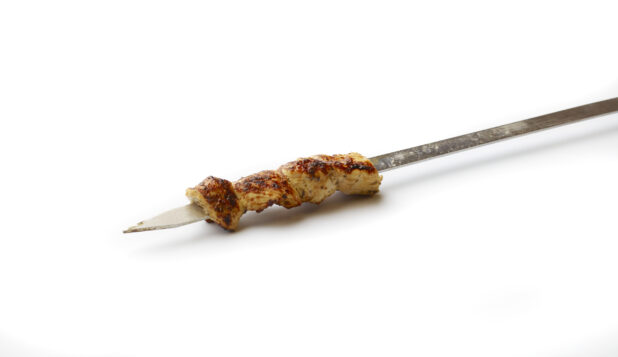 Chicken Souvlaki on a Metal Skewer, on a White Background for Isolation