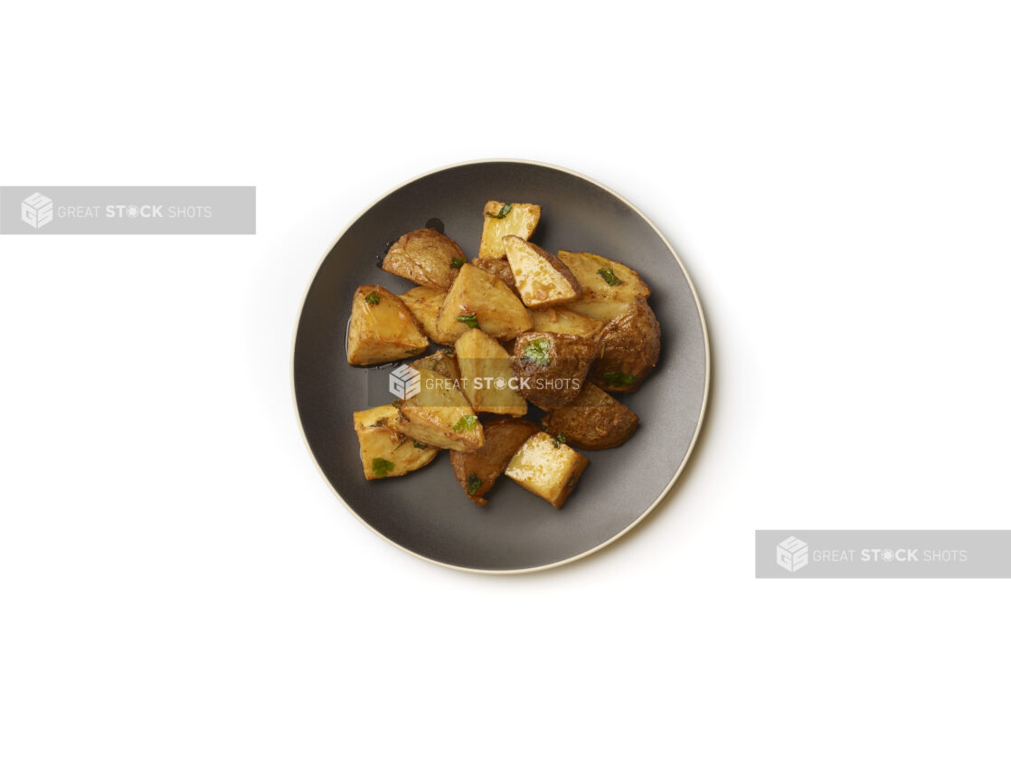 Overhead View of Garlic Potatoes on a Round Black Ceramic Dish, on a White Background for Isolation