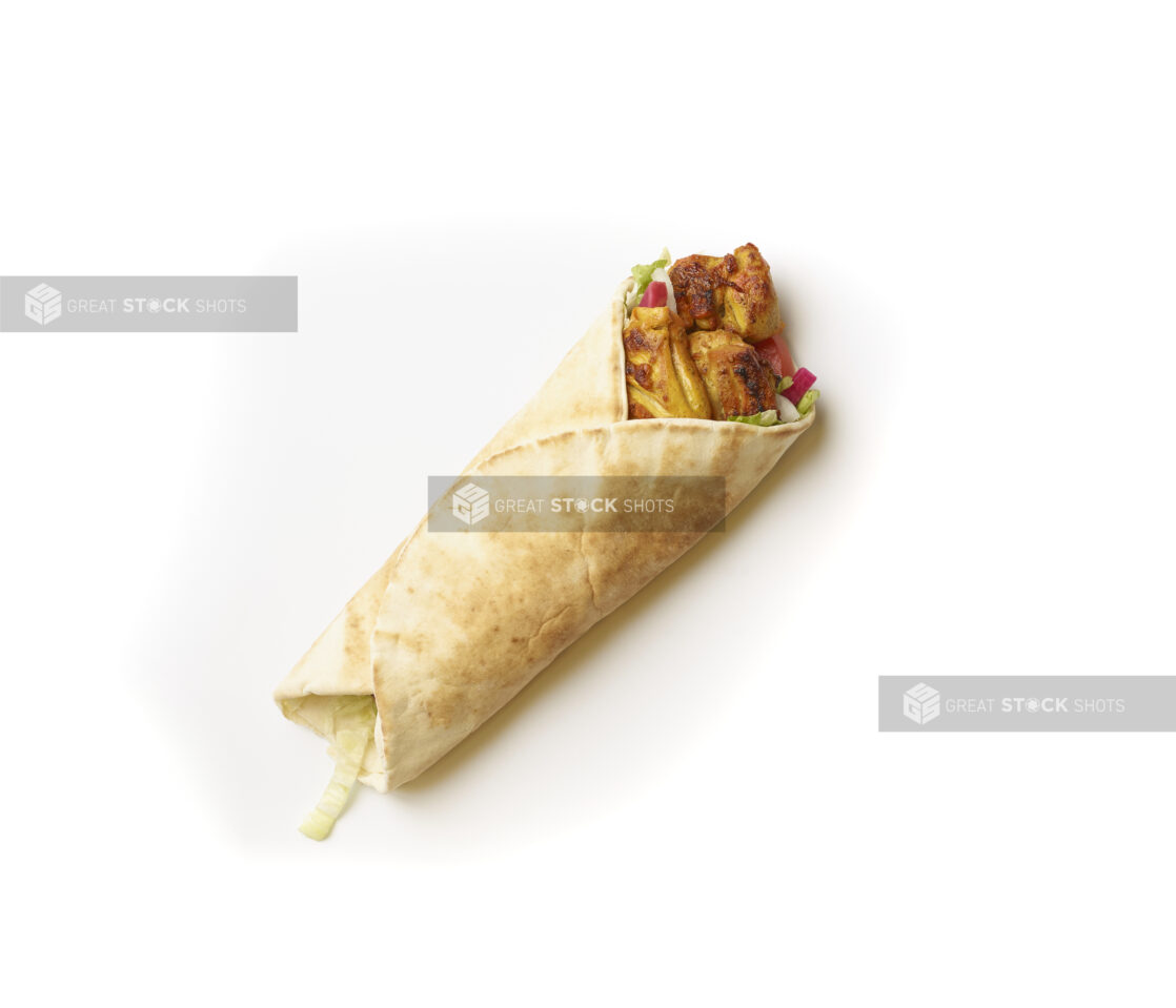 Overhead View of a Chicken Kebab Pita Wrap with Fresh Vegetable Toppings, Shot on White for Isolation