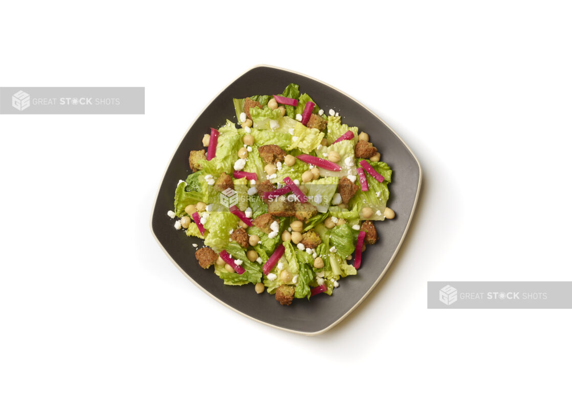 Overhead View of a Falafel and Chick Pea Salad with Red Pickled Turnip and Feta Cheese on a Square Black Ceramic Dish, on a White Background for Isolation