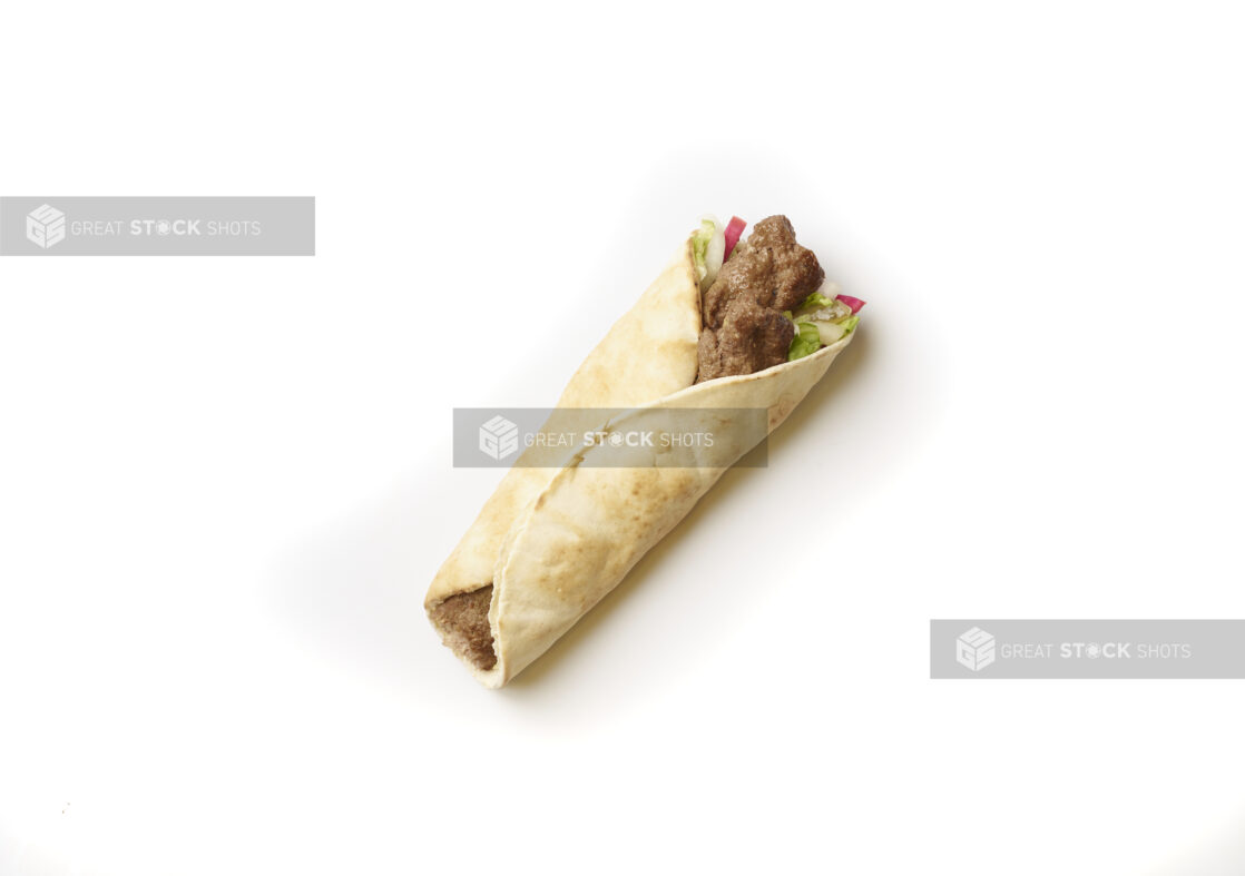 Overhead View of a Beef Kebab Pita Wrap with Fresh Vegetable Toppings, Shot on White for Isolation