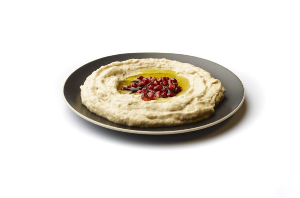 Plate of Baba Ganoush Creamy Eggplant Dip with EVOO and Pomegranate Seeds, Shot on White for Isolation