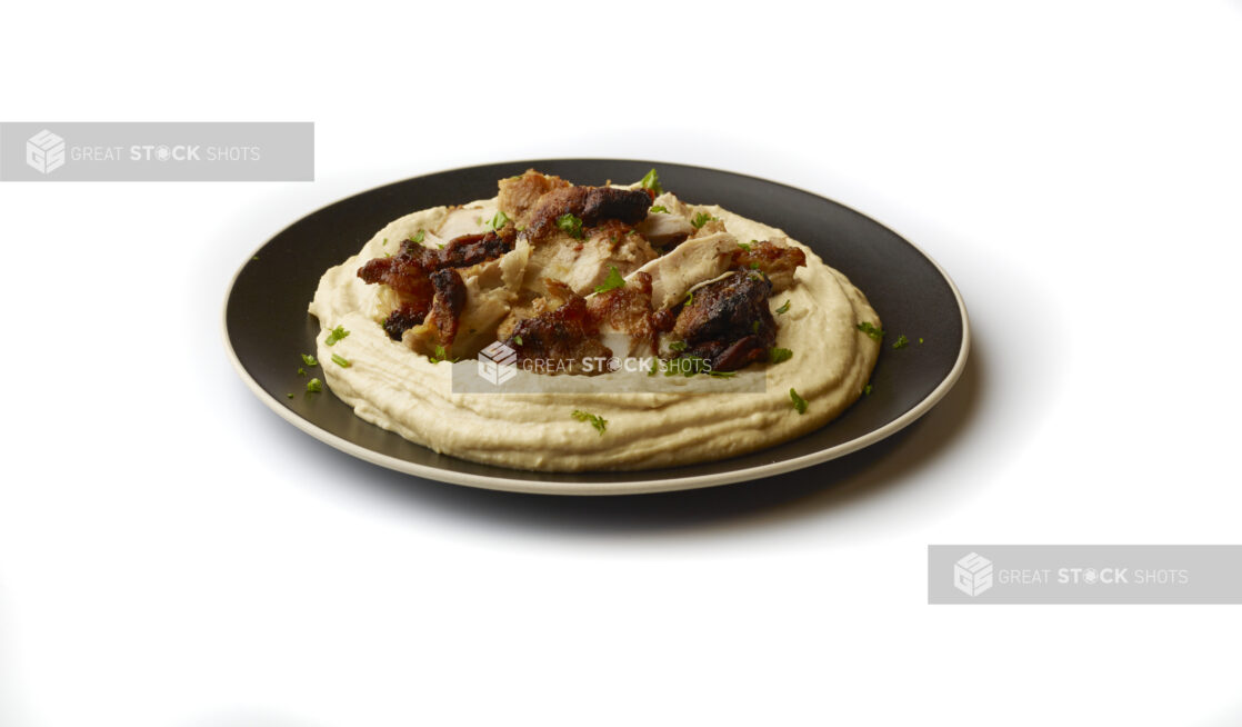 Plate of Hummus Dip with Extra Virgin Olive Oil, Chicken Shawarma and Fresh Parsley Flakes, Shot on a White Background for Isolation