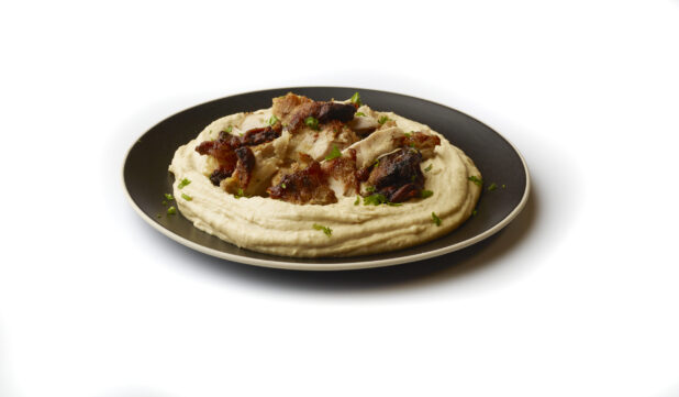 Plate of Hummus Dip with Extra Virgin Olive Oil, Chicken Shawarma and Fresh Parsley Flakes, Shot on a White Background for Isolation