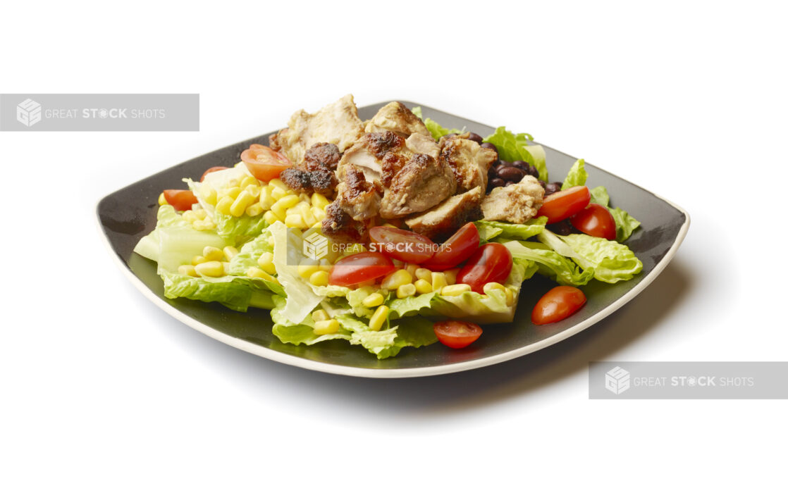 Chicken Shawarma Salad with Corn and Black Beans on a Square Black Ceramic Dish, on a White Background for Isolation