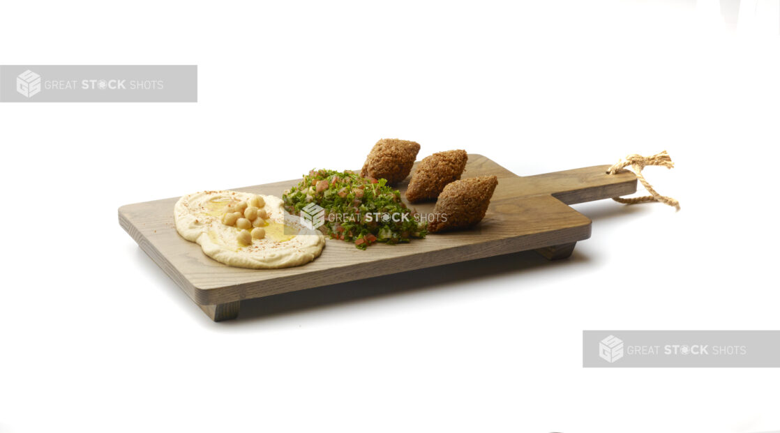 Trio Platter of Side Dishes: Falafel Balls, Tabbouleh and Hummus, on a Wooden Board on a White Background for Isolation