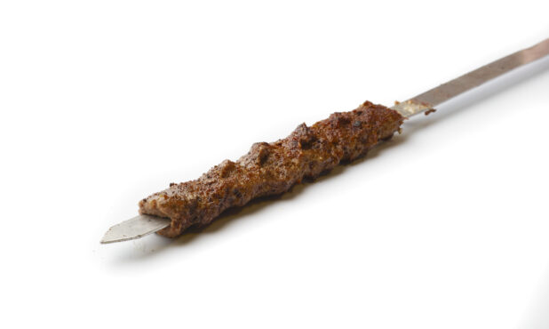 Beef Kebab on a Metal Skewer, on a White Background for Isolation