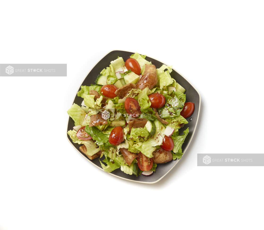 Overhead View of a Garden Salad with Gyro Meat and Balsamic Vinaigrette Drizzle on a Square Black Ceramic Dish, on a White Background for Isolation – Variation 2