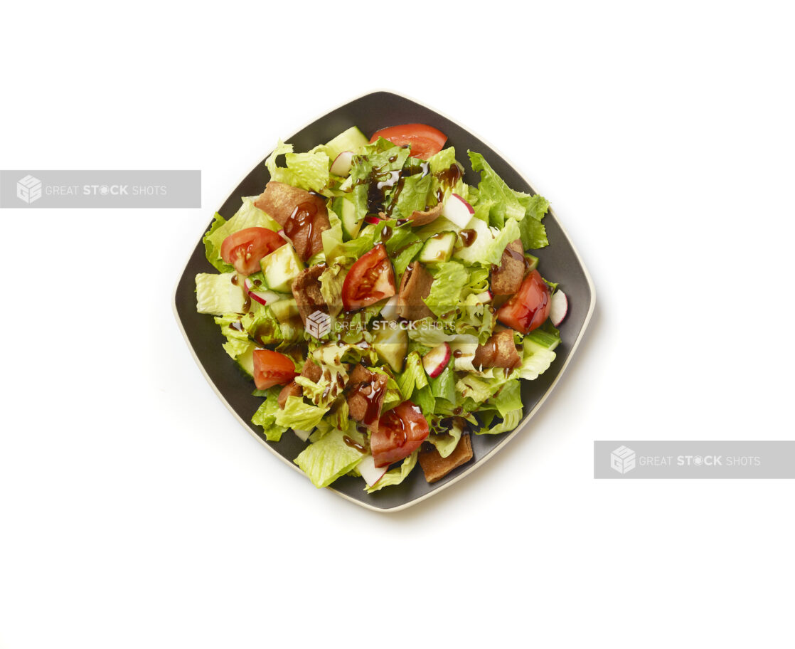 Overhead View of a Garden Salad with Gyro Meat and Balsamic Vinaigrette Drizzle on a Square Black Ceramic Dish, on a White Background for Isolation - Variation