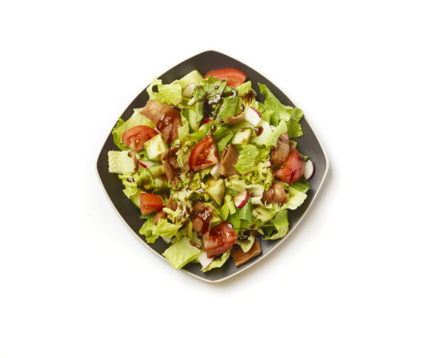 Overhead View of a Garden Salad with Gyro Meat and Balsamic Vinaigrette Drizzle on a Square Black Ceramic Dish, on a White Background for Isolation - Variation