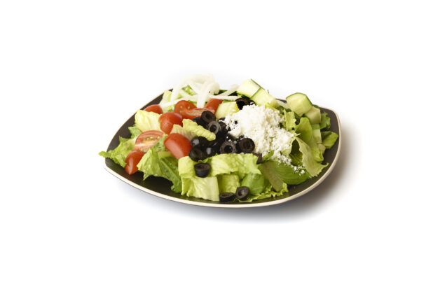 Plain Greek Salad with Cherry Tomatoes, Cucumber, Black Olives, Feta and White Onions on a Square Black Ceramic Dish, on a White Background for Isolation